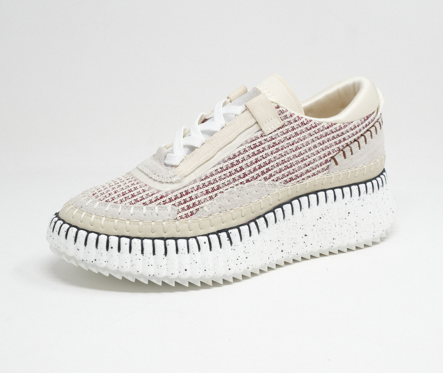 A pair of women's casual sneakers with lace-up design, featuring a textured fabric upper in beige and pink hues, and a platform sole.
