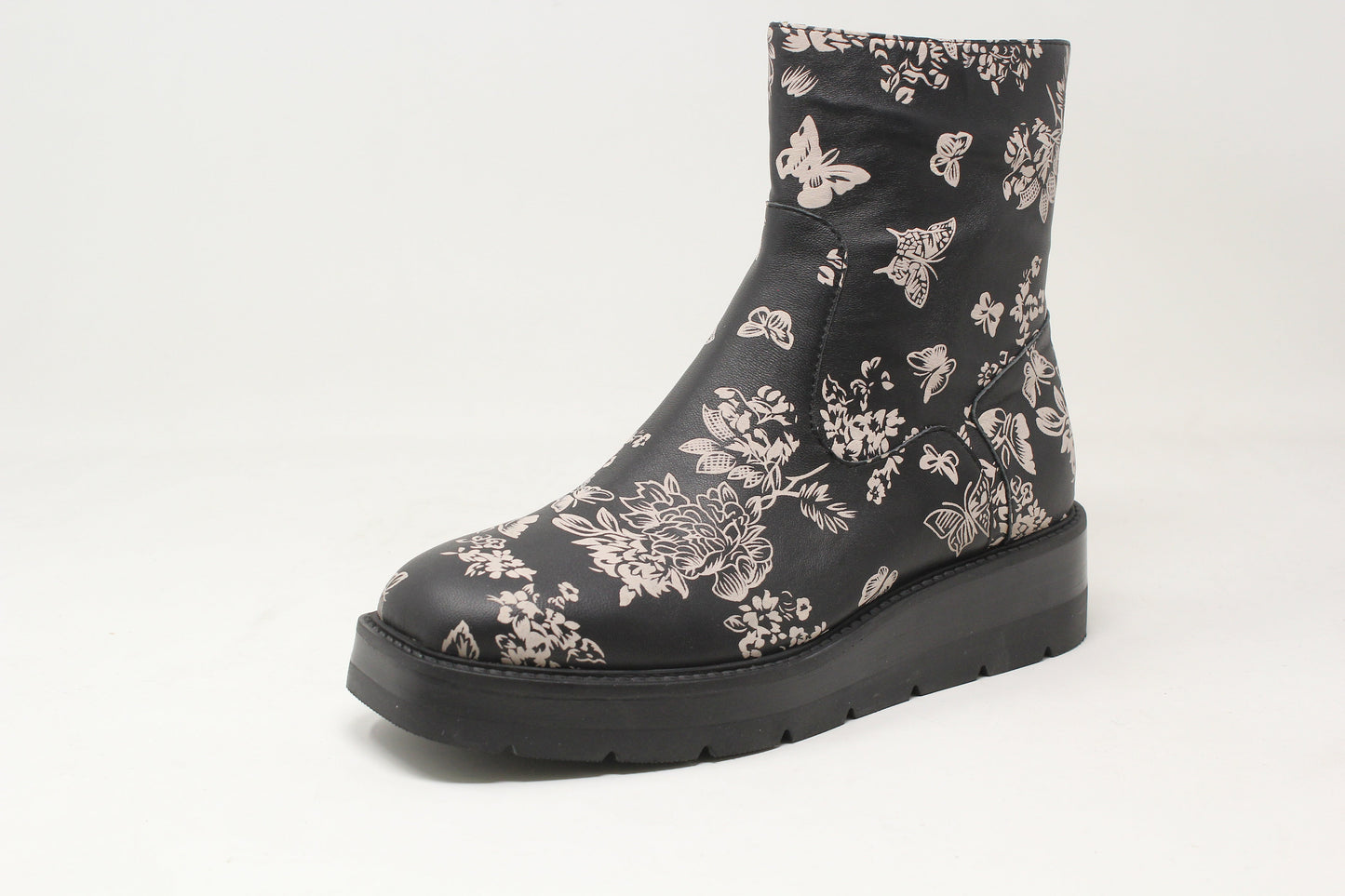 Black ankle boot with floral pattern on a white background