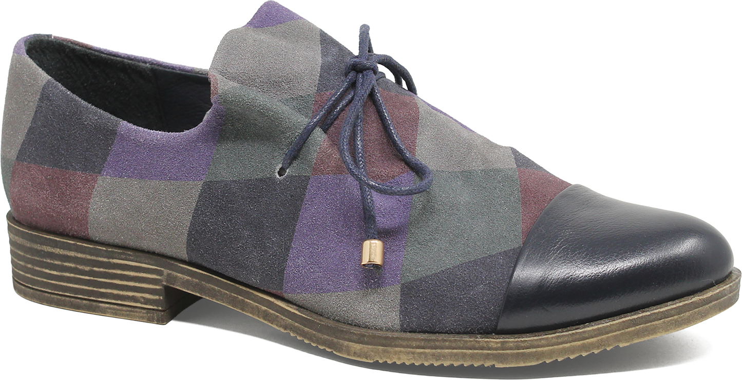 Multicolored checkered shoe with a black toe cap on a white background